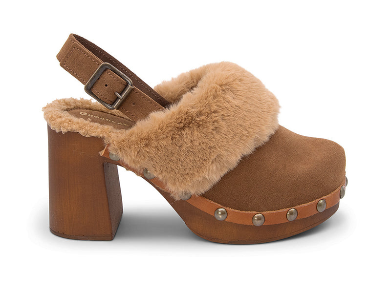 Brown heeled clog shoe with fur trim and grommet studs on a white side background side view