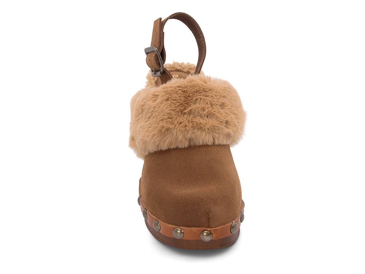 Brown heeled clog shoe with fur trim and grommet studs on a white side background front view