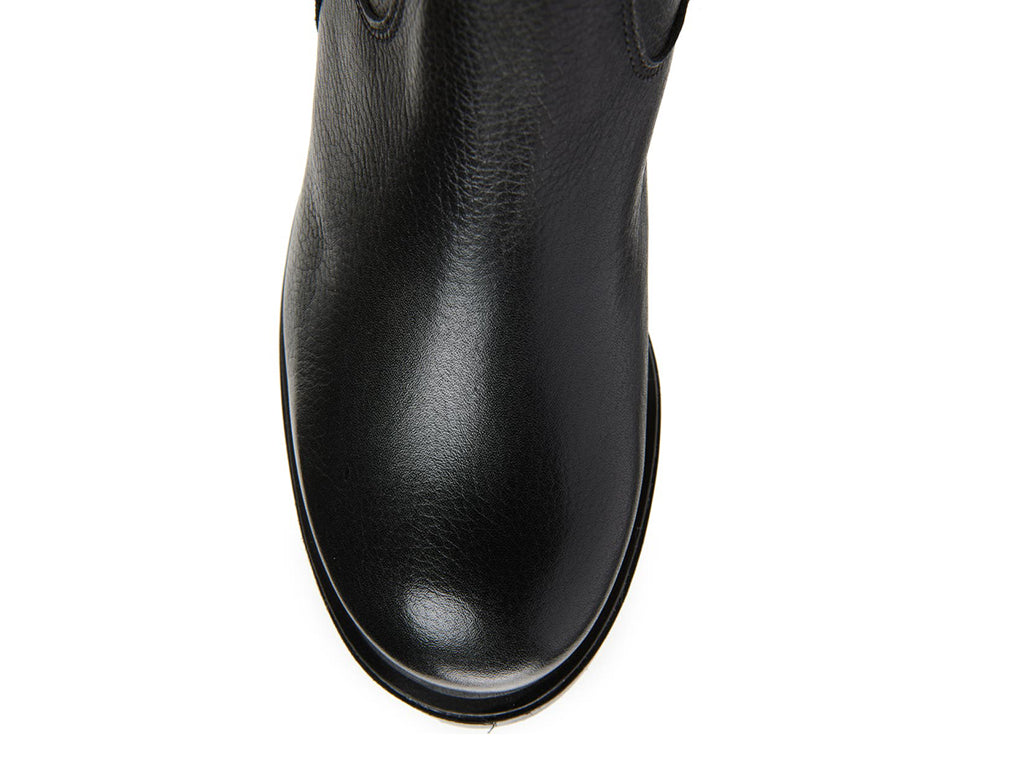 Black pull-on knee-high boot on a white background top view