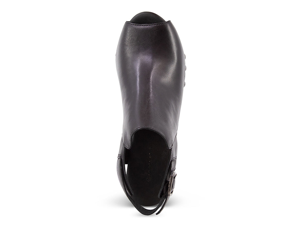 Black leather clog peep toe shoe with a block heel and grommet studs on a white background top view