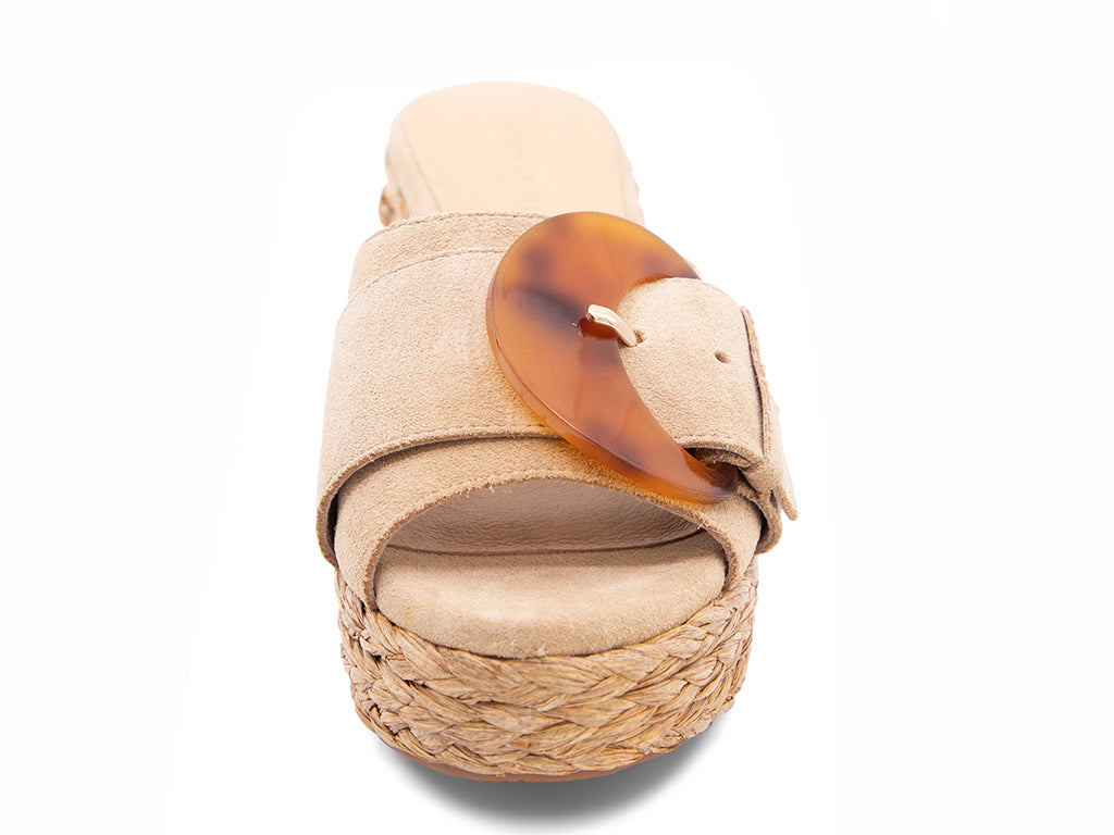 latte suede sandal with a moon shaped buckle on a raffia wrapped platform - front view