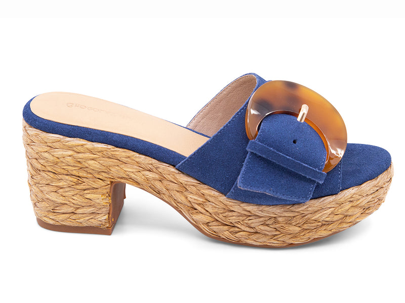 blue suede sandal with a moon shaped buckle on a raffia wrapped platform - side view