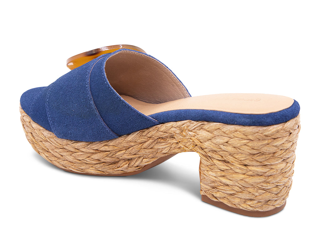 blue suede sandal with a moon shaped buckle on a raffia wrapped platform - back angle view