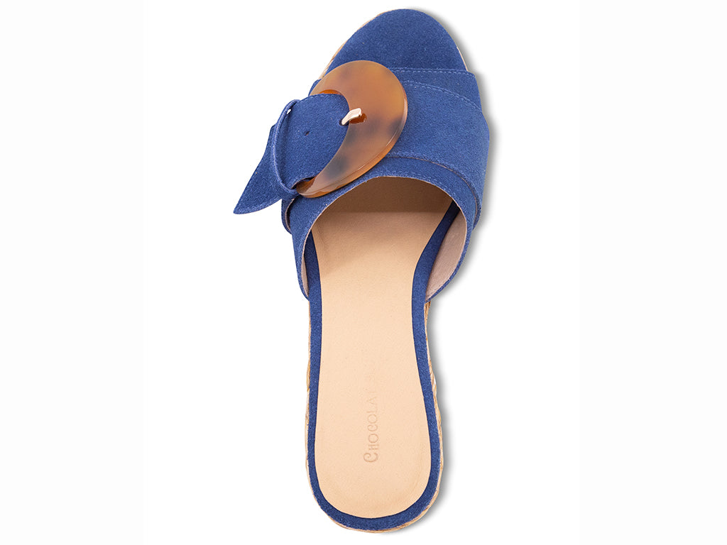 blue suede sandal with a moon shaped buckle on a raffia wrapped platform - top view