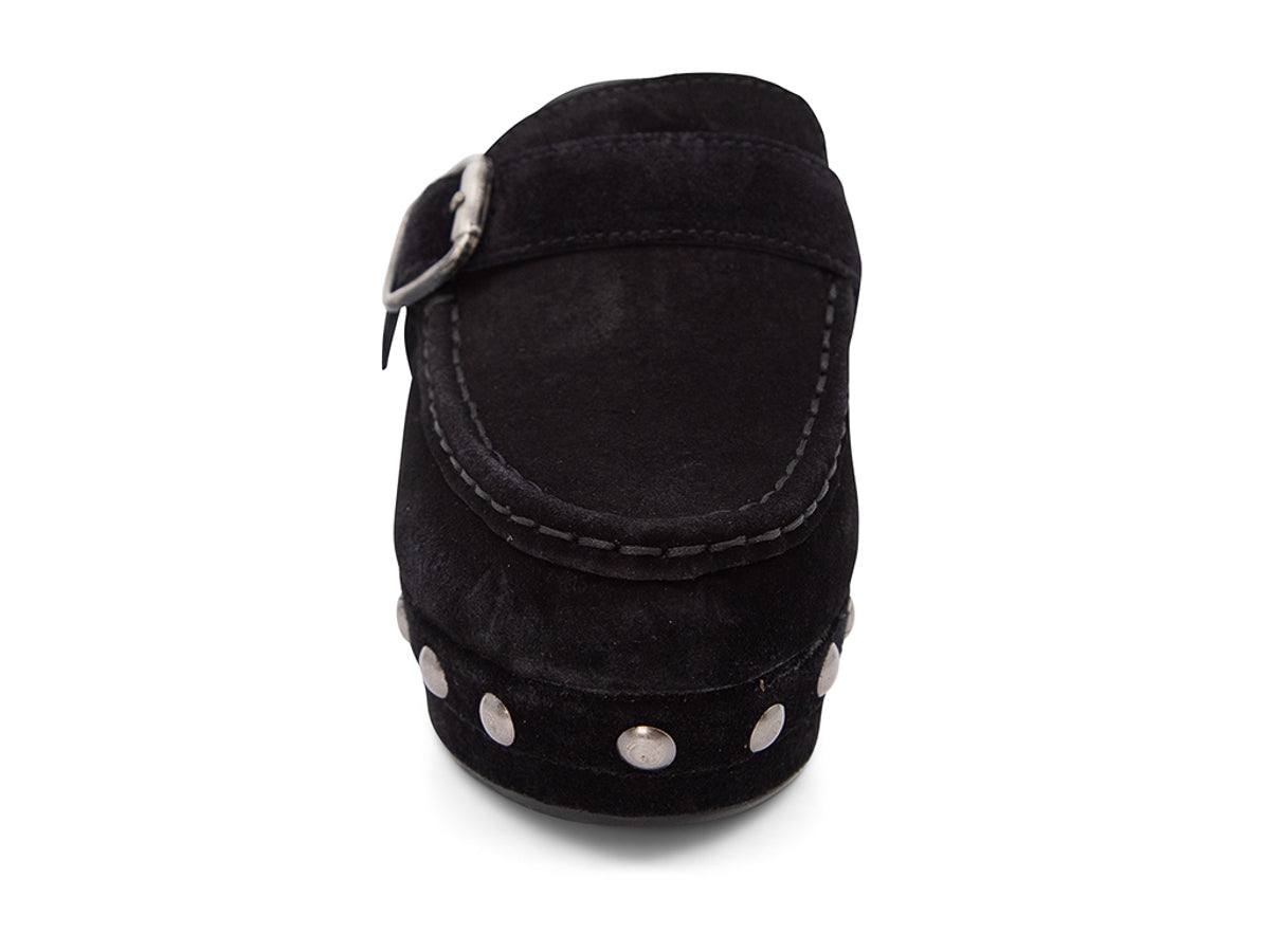 Black suede slide in block heel clog shoe with a decorative strap buckle and grommet studson a white background front view 