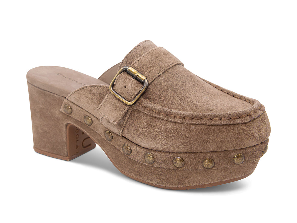 Toffee suede slide in block heel clog shoe with a decorative strap buckle and grommet studson a white background side angle view 