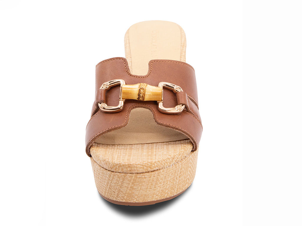 brown sandal with bamboo toggle buckle on a raffia wrapped platform and block heel - front view