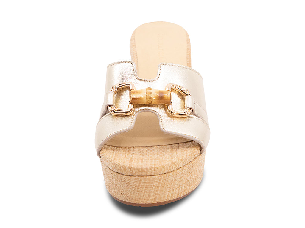 gold metallic sandal with bamboo toggle buckle on a raffia wrapped platform and block heel - front view