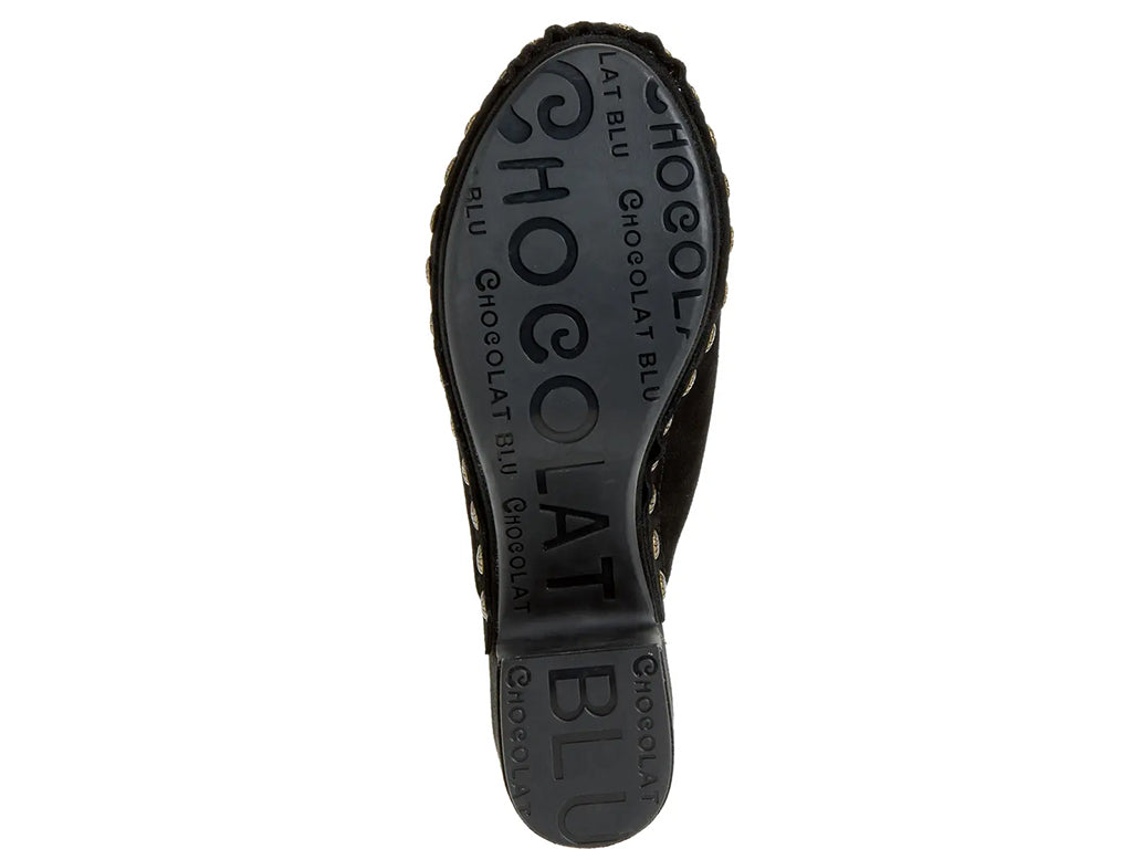black suede clogs on a chunky platform with decorative metallic flower-shaped studs along the side - outsole view