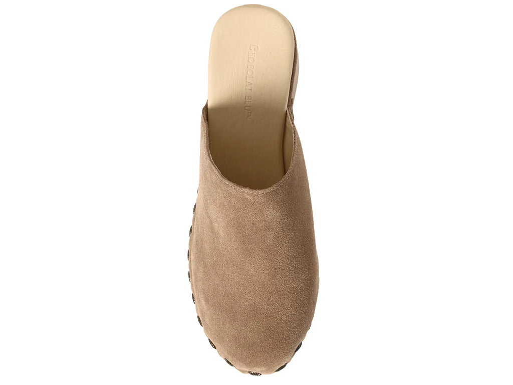 latte suede clogs on a chunky platform with decorative metallic flower-shaped studs along the side - top view