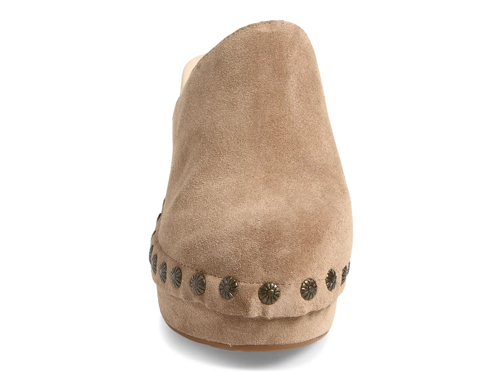 latte suede clogs on a chunky platform with decorative metallic flower-shaped studs along the side - front view