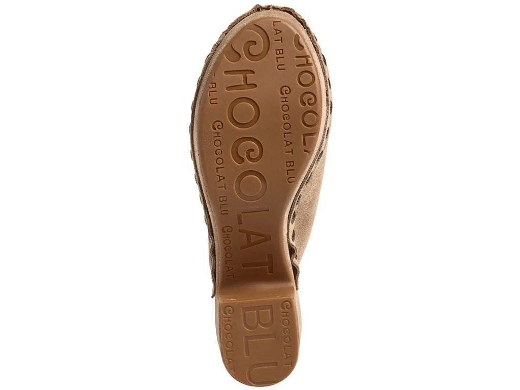 latte suede clogs on a chunky platform with decorative metallic flower-shaped studs along the side - outsole view