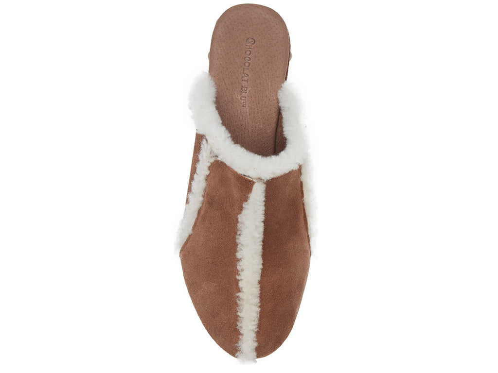 Brown suede platform heeled clog with white fur lining and gold studs on a white background top view