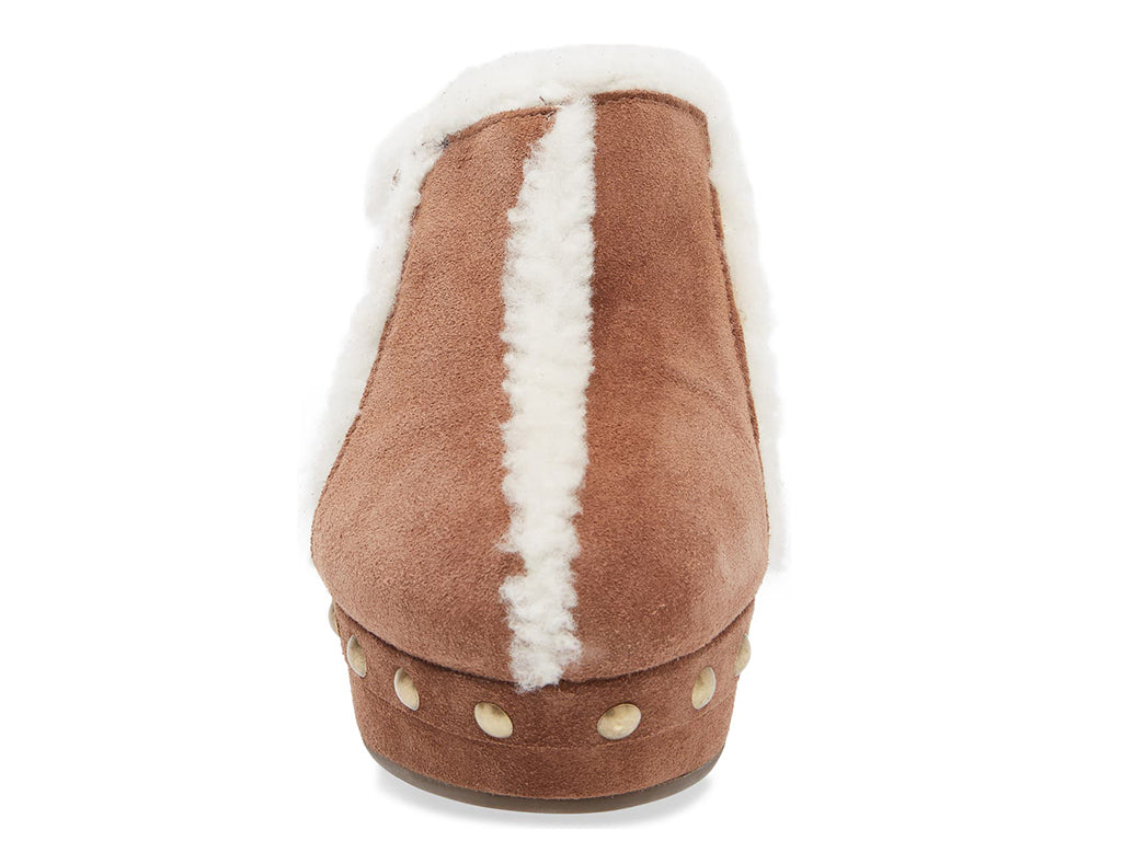 Brown suede platform heeled clog with white fur lining and gold studs on a white background front view