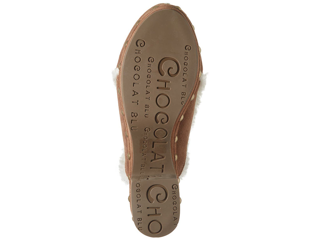 Brown suede platform heeled clog with white fur lining and gold studs on a white background bottom sole view