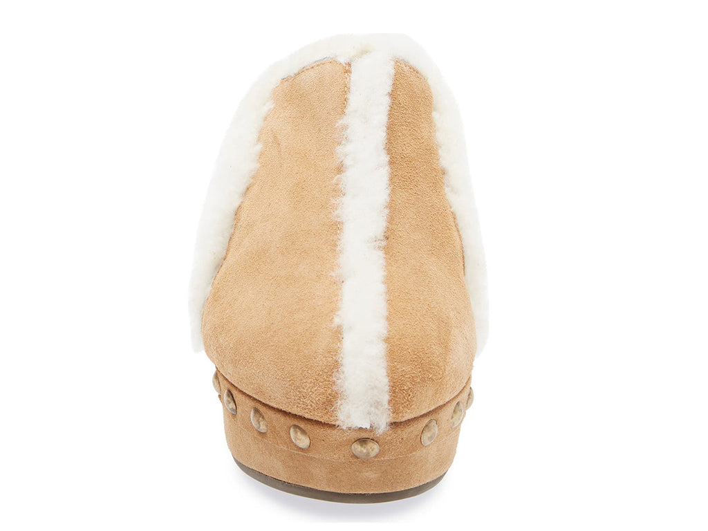 Tan suede platform heeled clog with white fur lining and gold studs on a white background front view