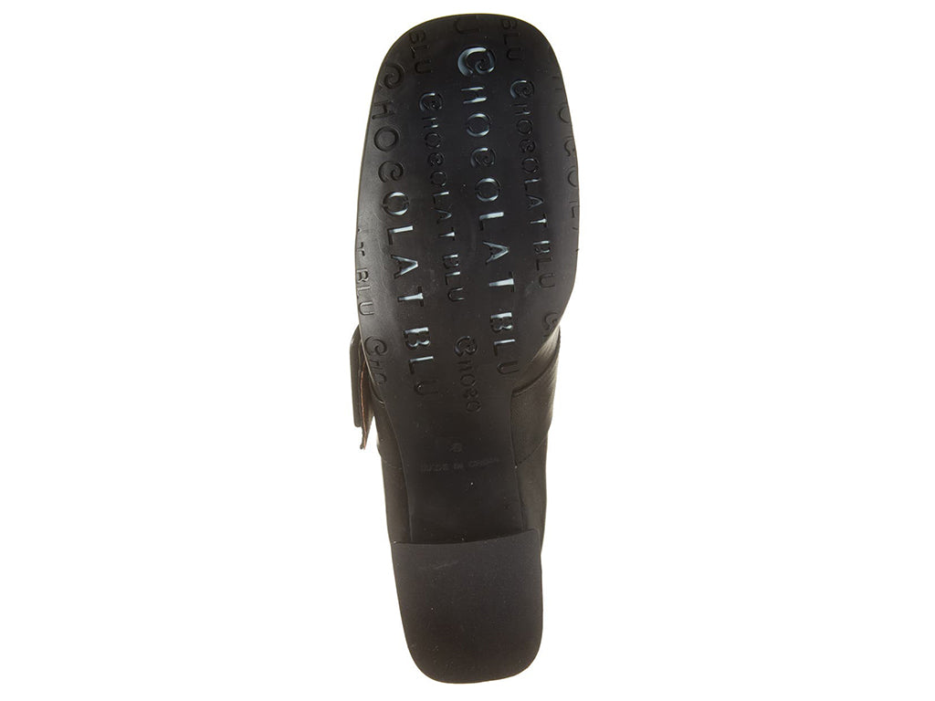 Black leather shoe with block heel and decorative buckle on strap kaying over instep on a white background bottom sole view