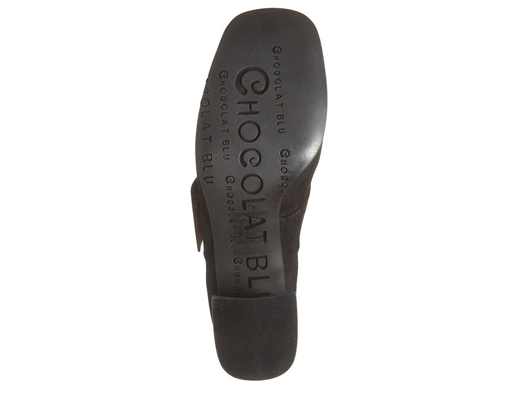 Black suede shoe with block heel and decorative buckle on strap kaying over instep on a white background bottom sole view