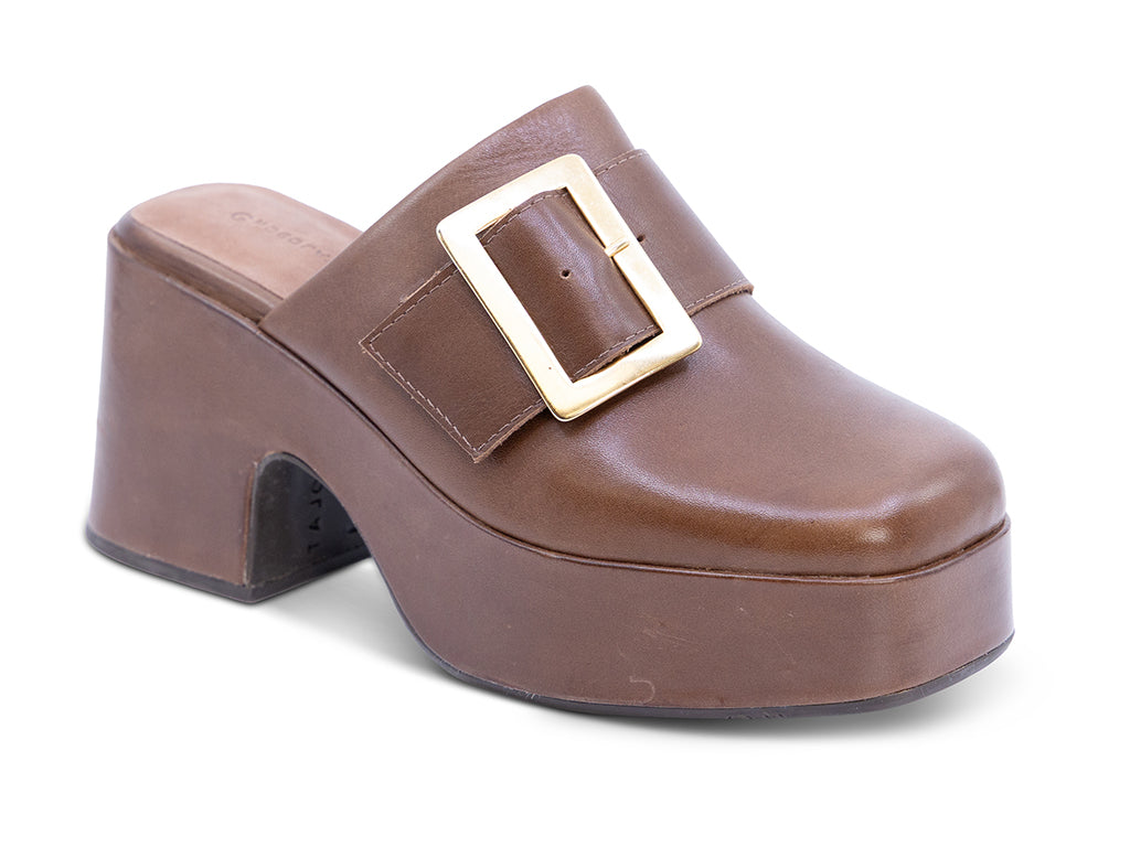 A brown leather platform clog shoe with a chunky block heel and a large gold-tone rectangular buckle - front 3/4 view