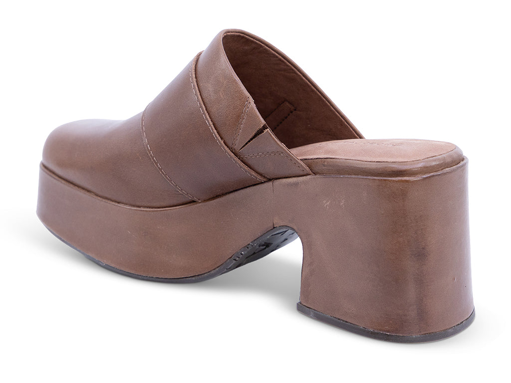 A brown leather platform clog shoe with a chunky block heel and a large gold-tone rectangular buckle - inner side view