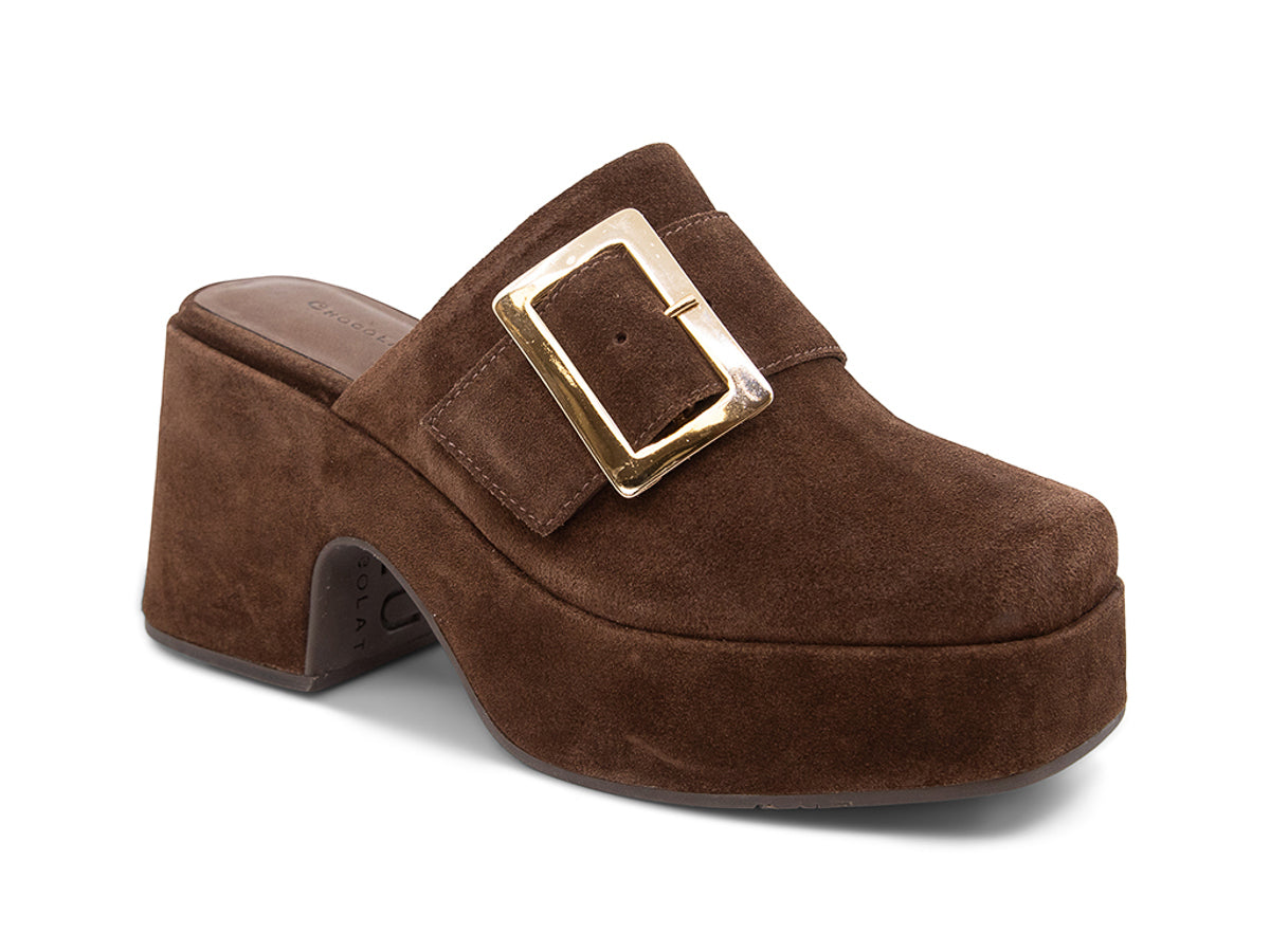 Brown suede platform slide in block heeled clog with gold buckle on a white background side angle view