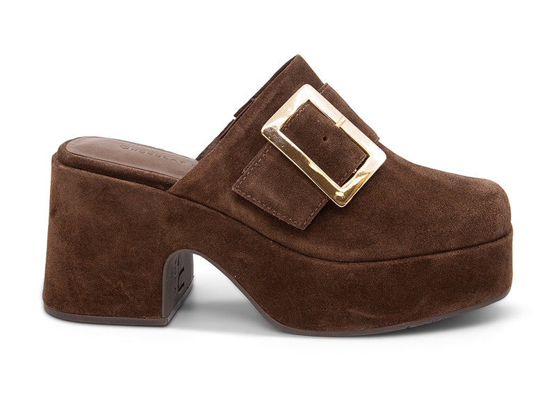Brown suede platform slide in block heeled clog with gold buckle on a white background side view