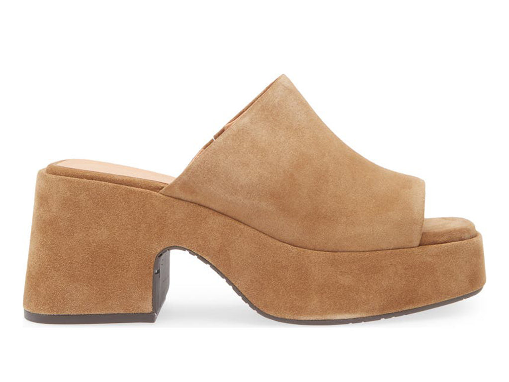 Tan chunky heeled open toed platform mule with a suede upper on a white background side view
