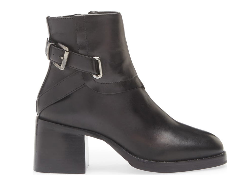Black ankle boot with silver buckle and criss cross strap design on a white background side view
