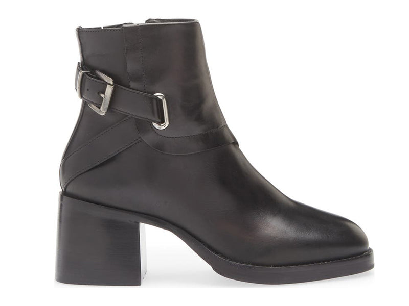 Black ankle boot with silver buckle and criss cross strap design on a white background side view