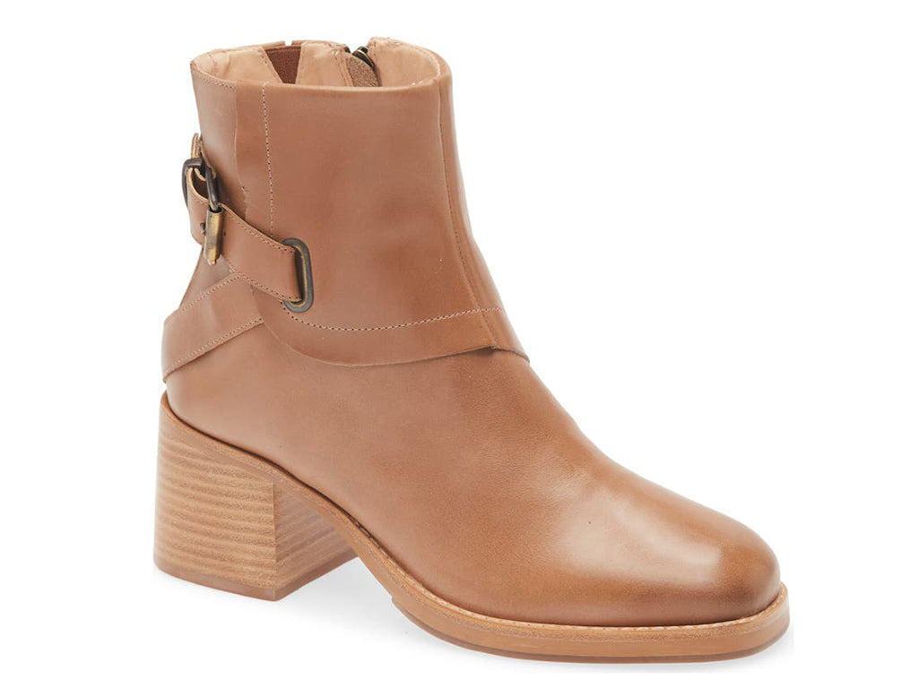 Tobacco color ankle boot with buckle and criss cross strap design on a white background side angle view