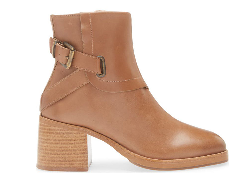 Tobacco color ankle boot with buckle and criss cross strap design on a white background side view
