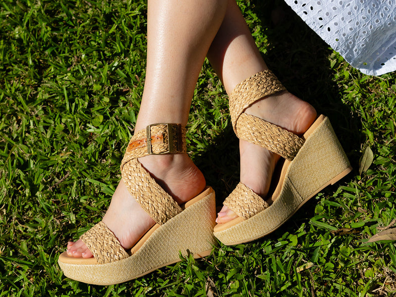 Isabel natural raffia wedge sandal on a model