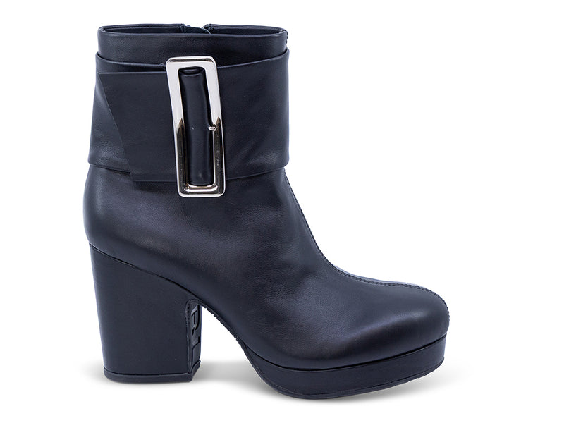 black ankle boot on a platform with wide wraparound strap and oversized buckle - front 3/4 view - lateral side view