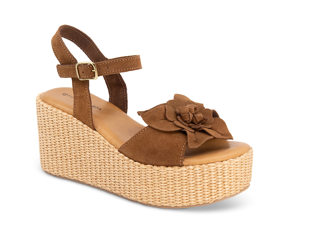 Brown wedge sandal with a flower detail and an ankle strap