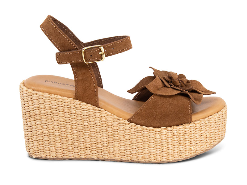 Brown wedge sandal with a flower detail and an ankle strap - side view