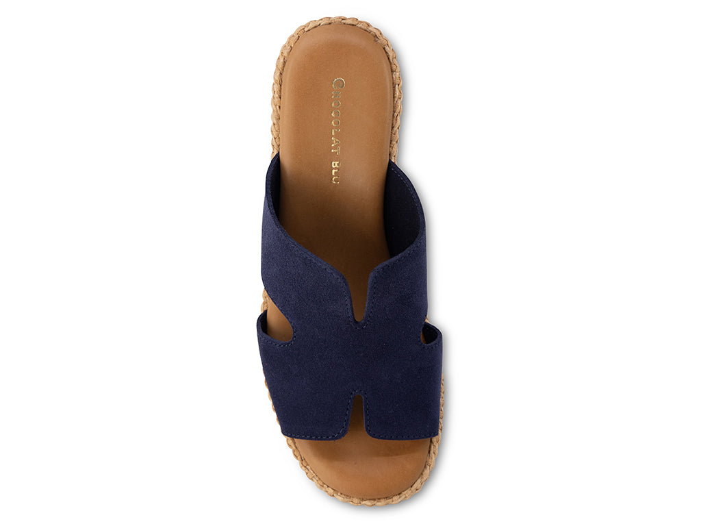 Navy sandal with tan sole on a white background