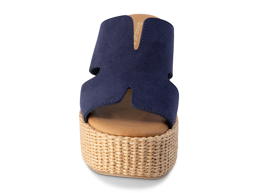 Navy wedge sandal with woven sole on a white background