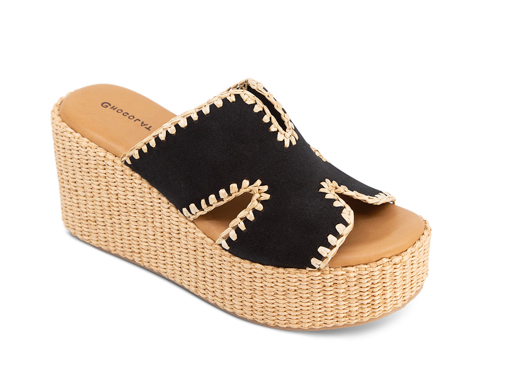 black suede slide sandal on a raffia wrapped wedge