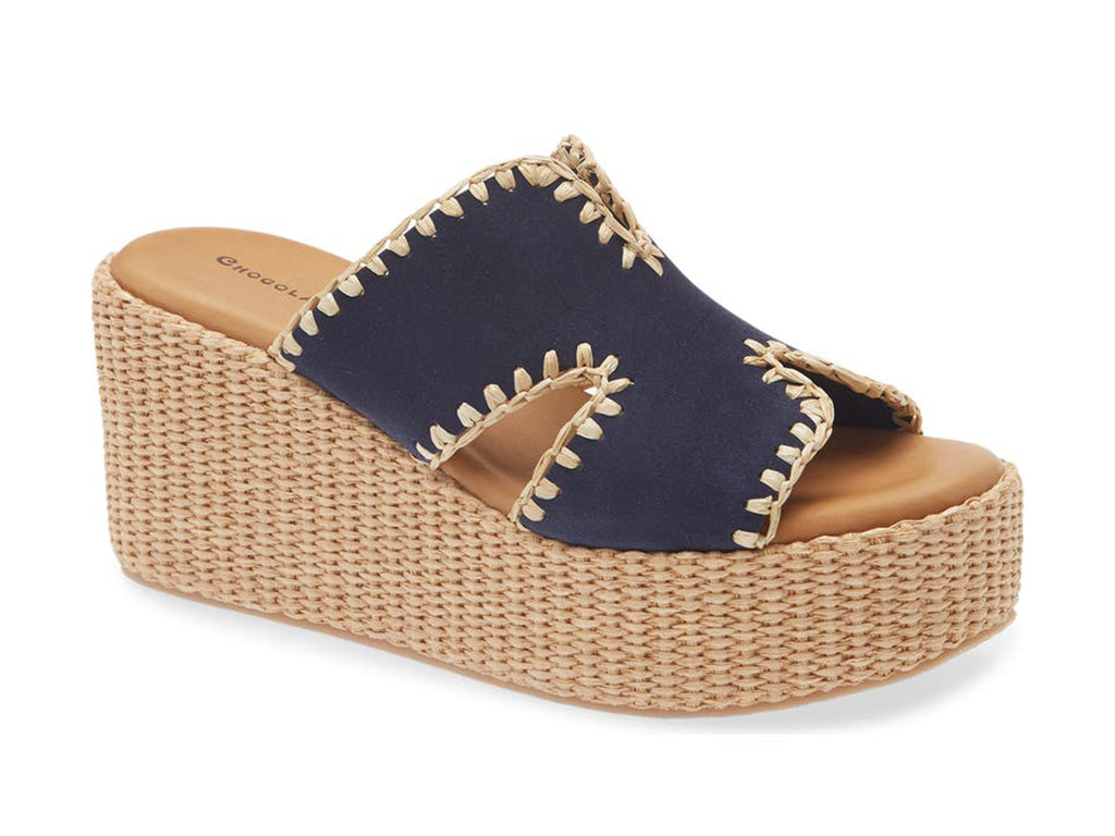 navy suede slide sandal on a raffia wrapped wedge