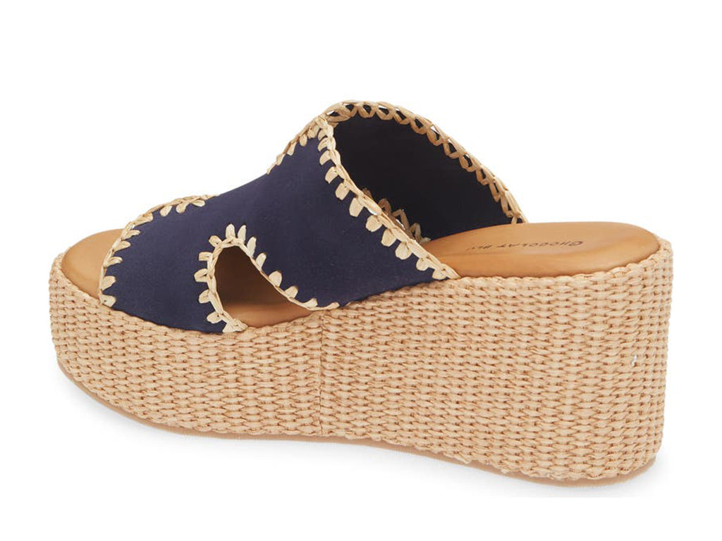 navy suede slide sandal on a raffia wrapped wedge-back
