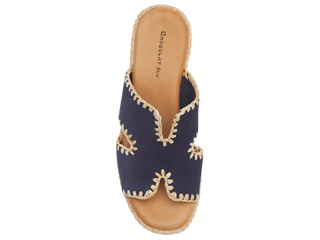 navy suede slide sandal on a raffia wrapped wedge-top