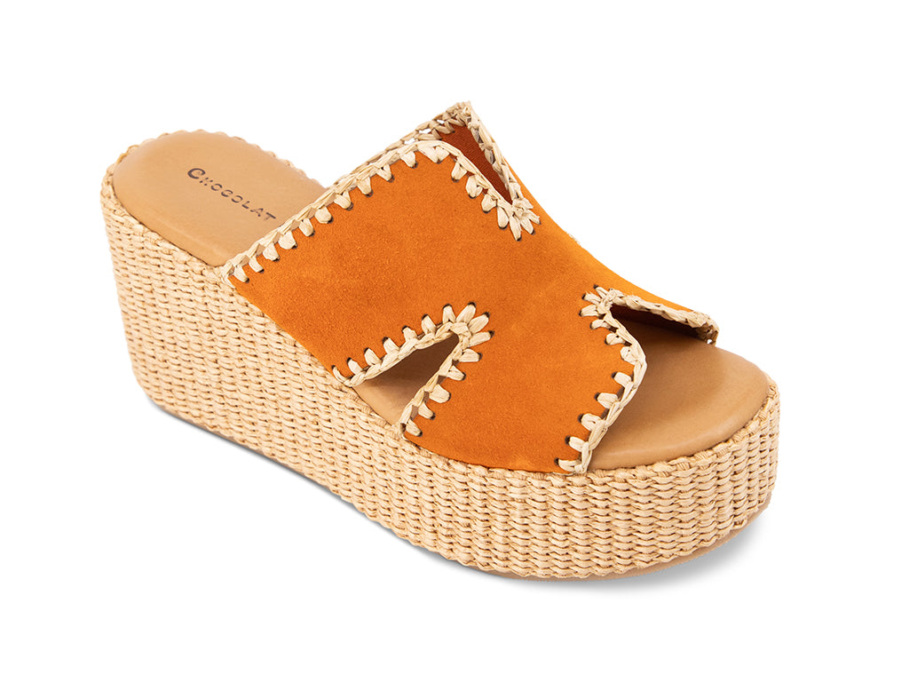 orange suede slide sandal on a raffia wrapped wedge