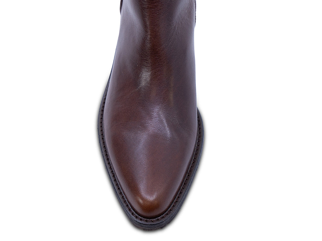 A dark brown leather ankle boot with a low block heel and a pull tab at the top - view of the toe shape