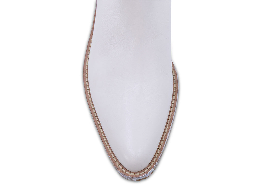 off white leather ankle boot with a low stacked block heel and a pull tab at the top - view of the toe shape