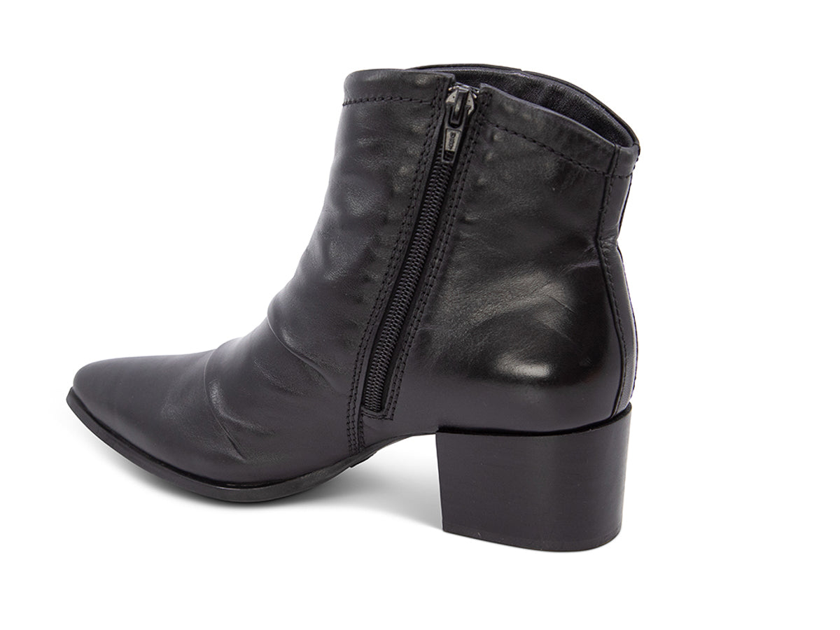 Black leather ankle boot on a white background side angle view with zipper
