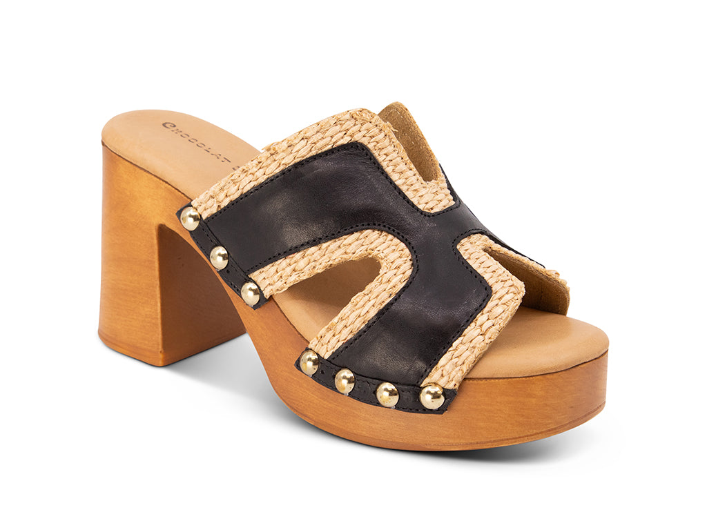 brown slide sandal on a high wooden platform with raffia and black leather upper