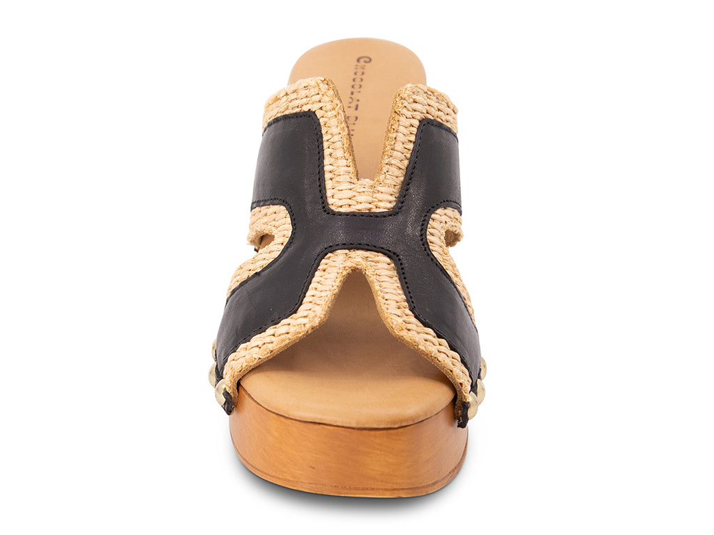 brown slide sandal on a high wooden platform with raffia and black leather upper - view from the front