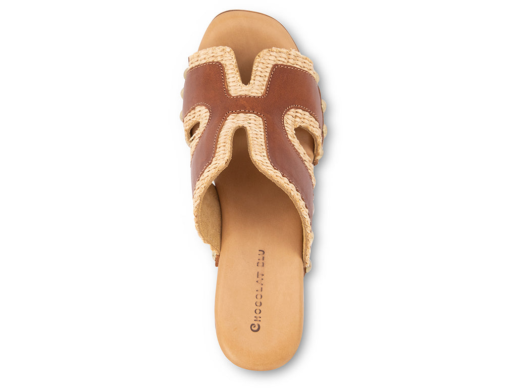 brown slide sandal on a high wooden platform with raffia and brown leather upper - top view