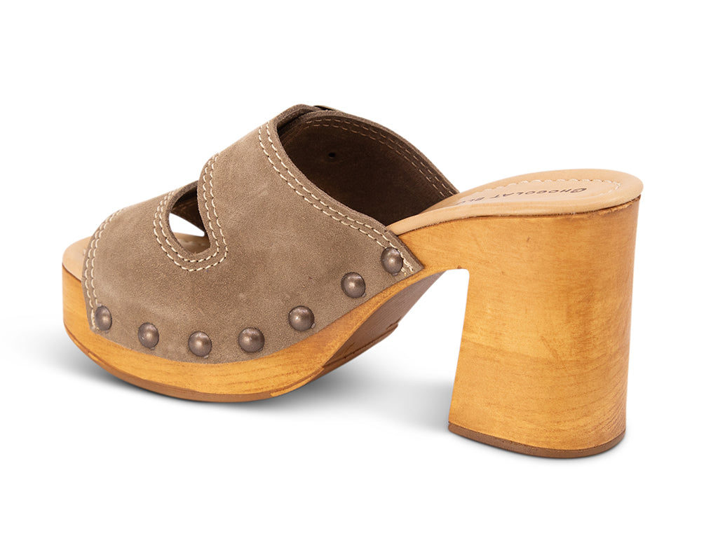 taupe suede slide sandal on wooden platform -view from the back