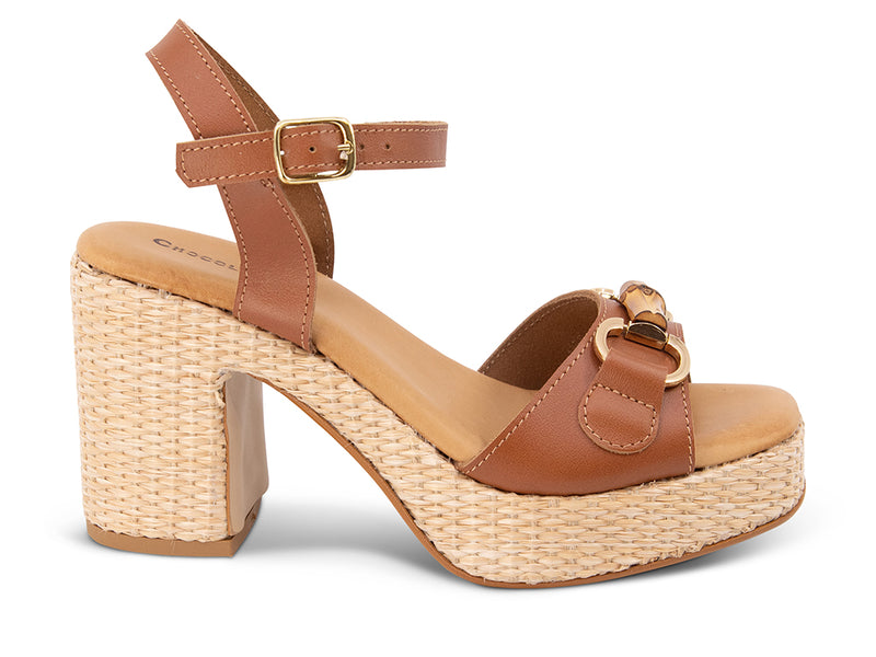 brown sandal with an ankle strap and a raffia wrapped platform - side view